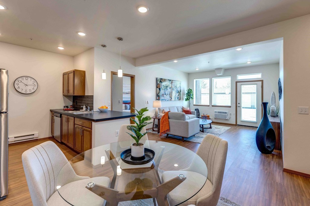 a dining room and living room area with a glass table and chairs