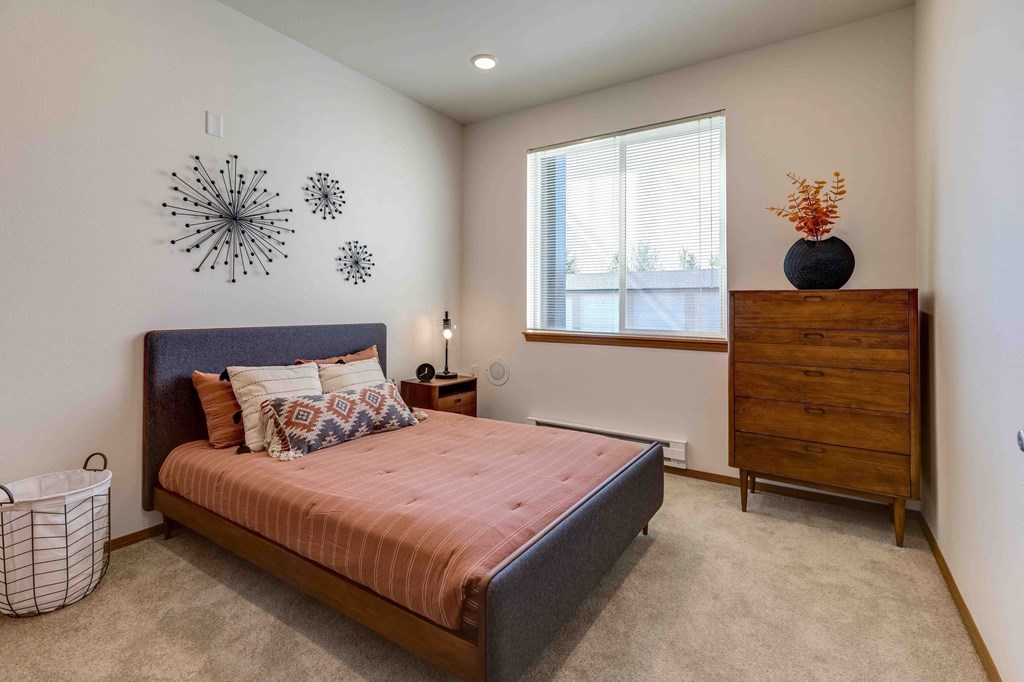 a bedroom with a bed and a dresser