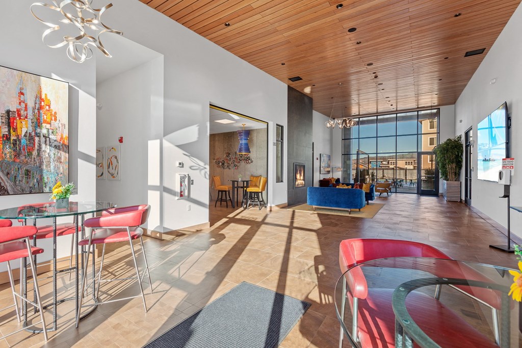 a room with a table and chairs and a large window