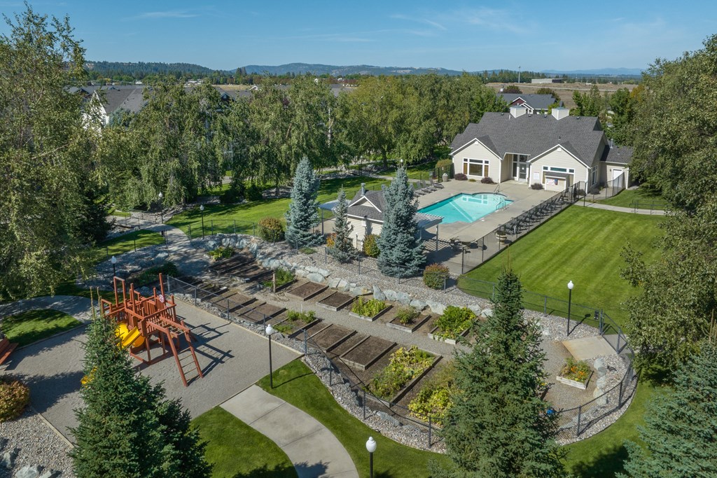 an aerial view of a backyard with a pool and a house