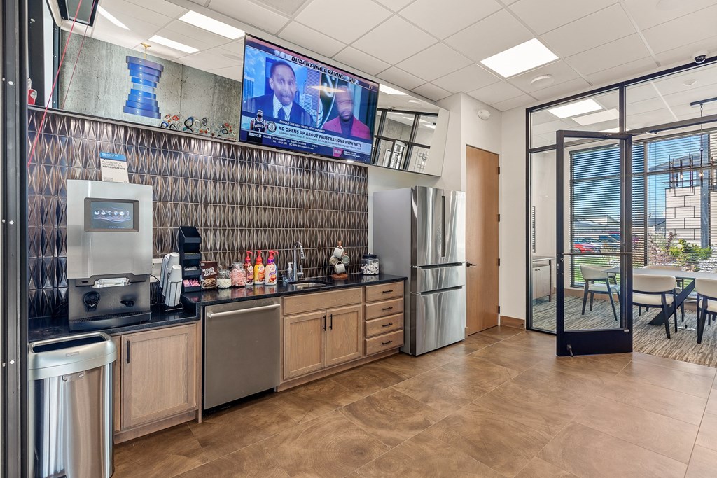 a kitchen with a refrigerator freezer next to a stove top oven