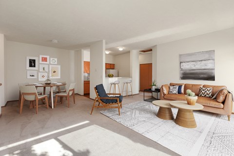 the living room and dining room of a house with a table and chairs