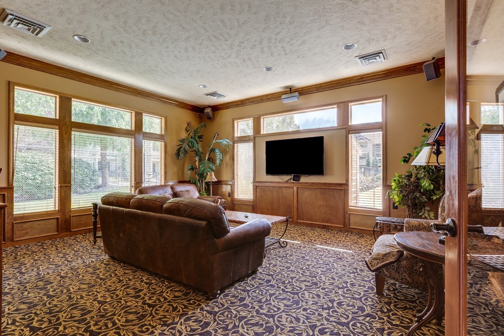 Clubroom filled with furniture and a flat screen tv