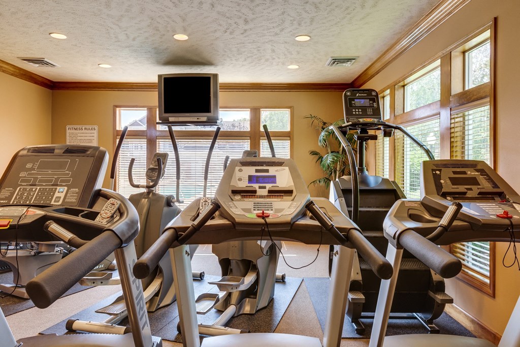 a room filled with lots of cardio equipment