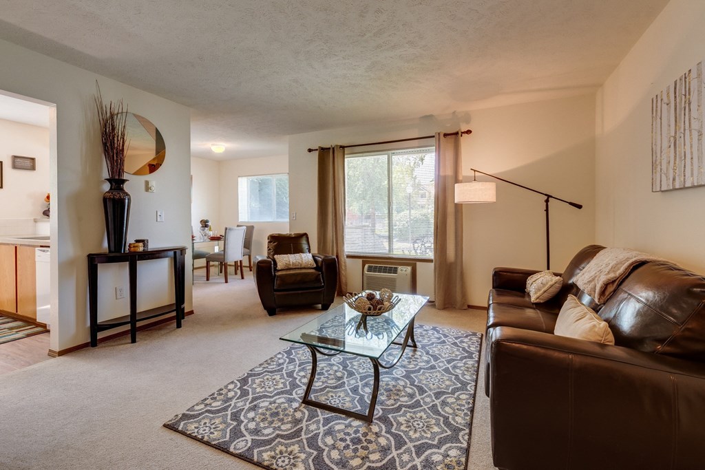 a living room with a couch and chair and a coffee table