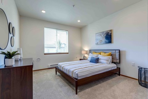 a bedroom with a bed and a dresser