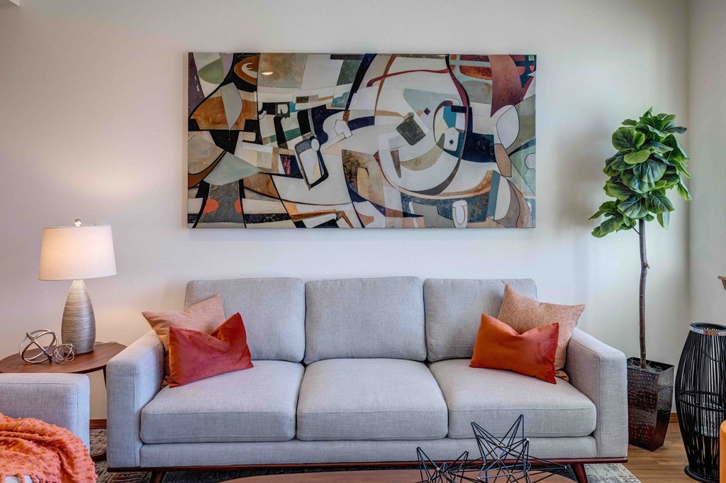 a living room with a couch and a potted plant