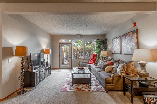 a living room with a couch coffee table and television