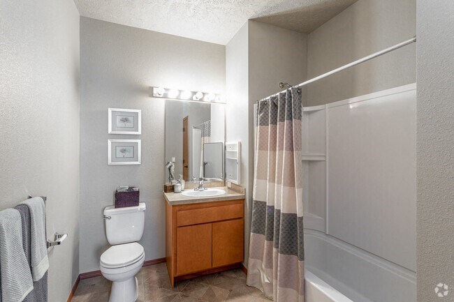 a bathroom with a toilet sink and shower