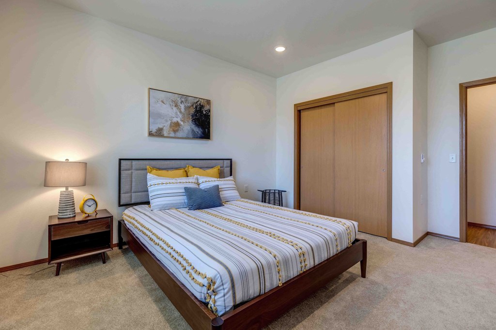 a bedroom with a bed and a nightstand