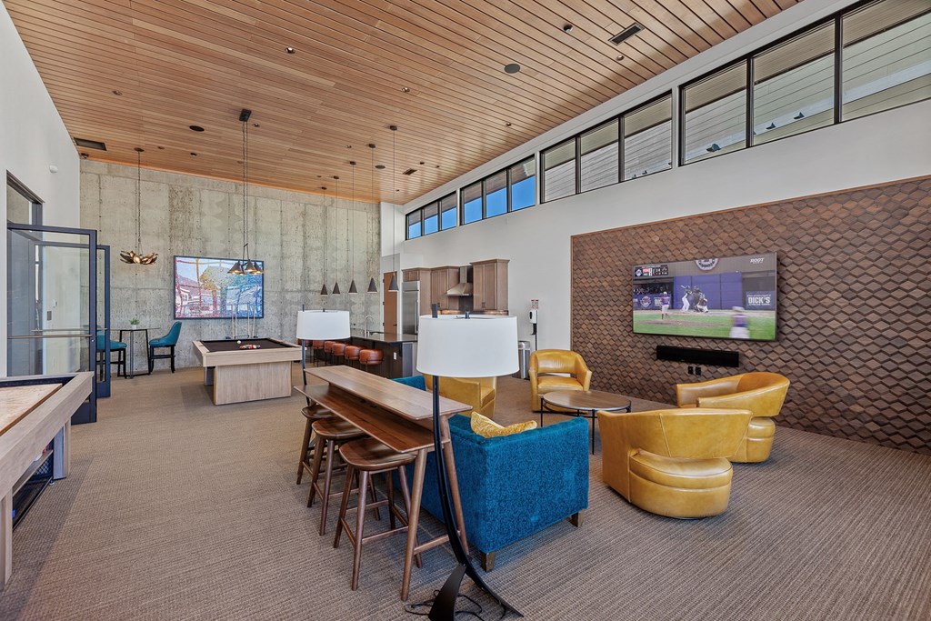 a large room with a large table and chairs and a flat screen tv on the wall