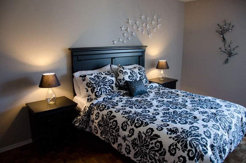 a bedroom with a bed and two lamps