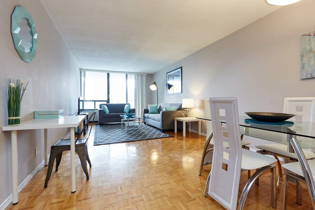 a living room and dining room with a table and chairs