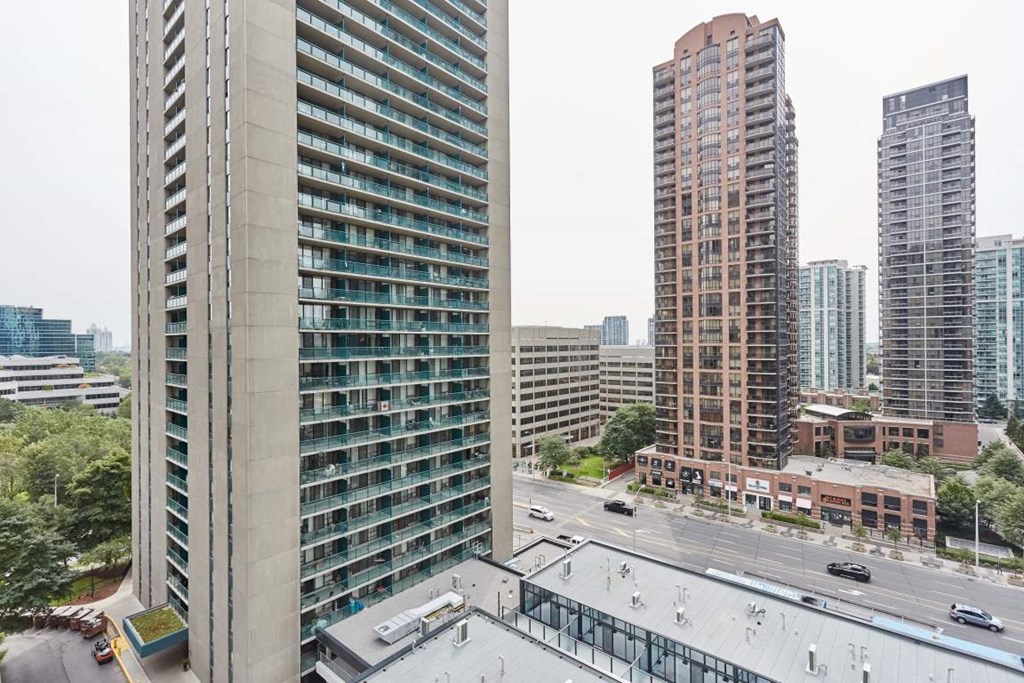 a view of the city from the balcony of a high rise building