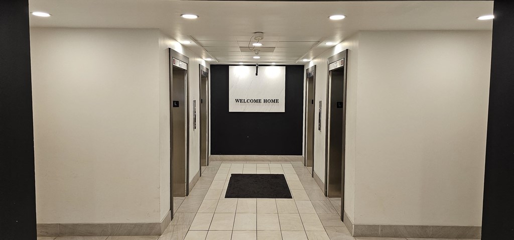 a look down the hallway of a building with a white sign on the wall that says the