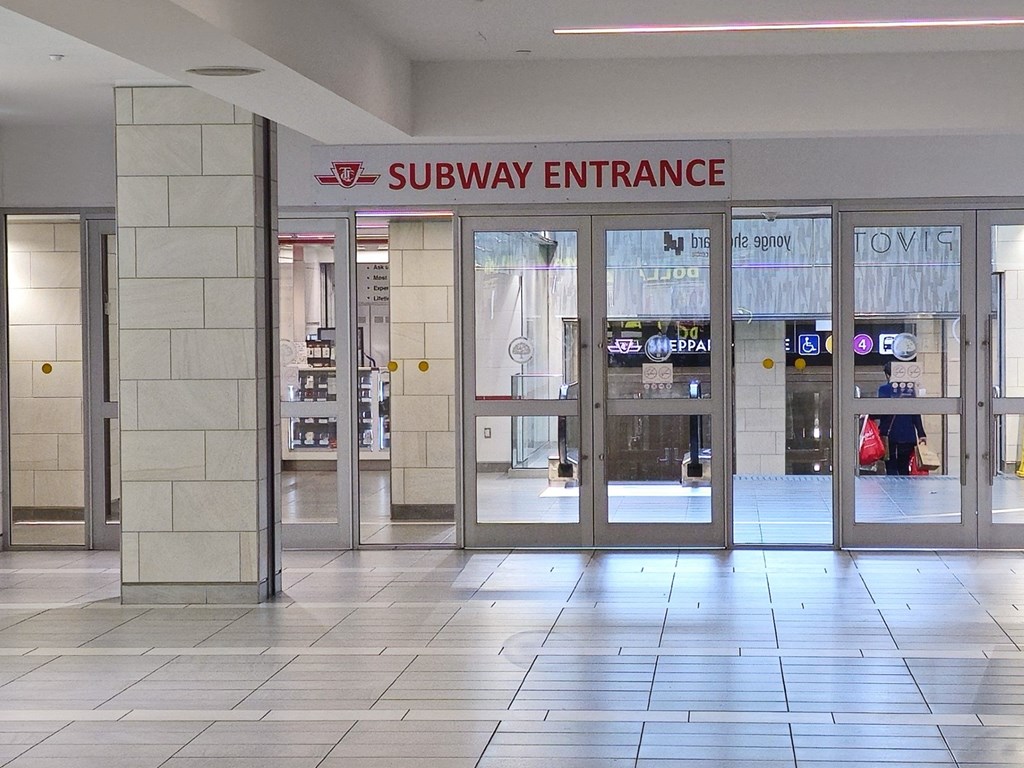 a subway entrance in a building with a tiled floor