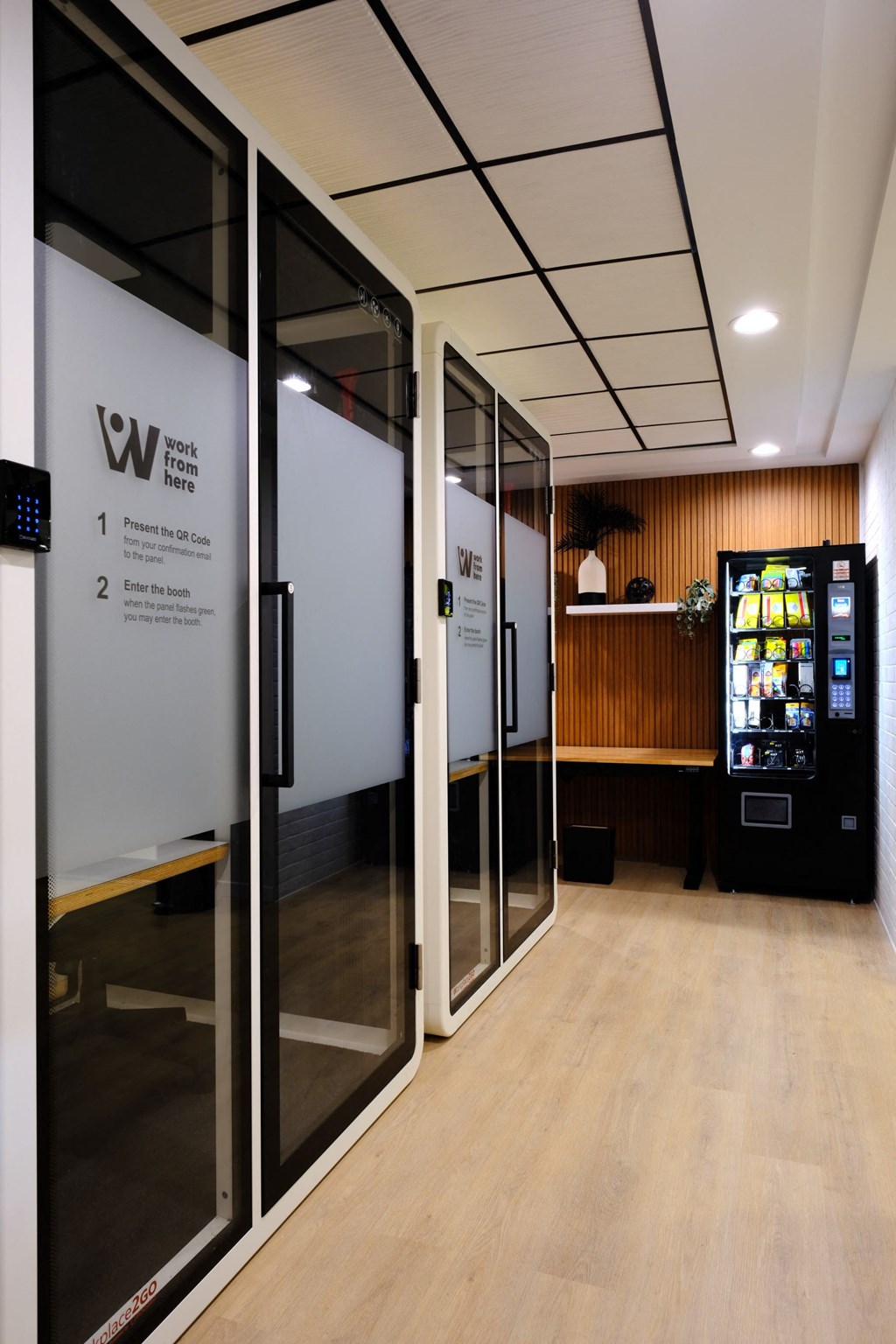 a lobby with glass doors and a vending machine