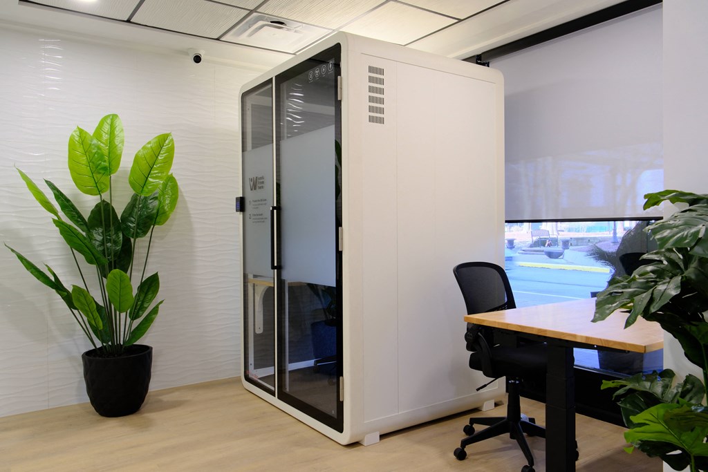 a privacy wall in an office with a desk and a chair