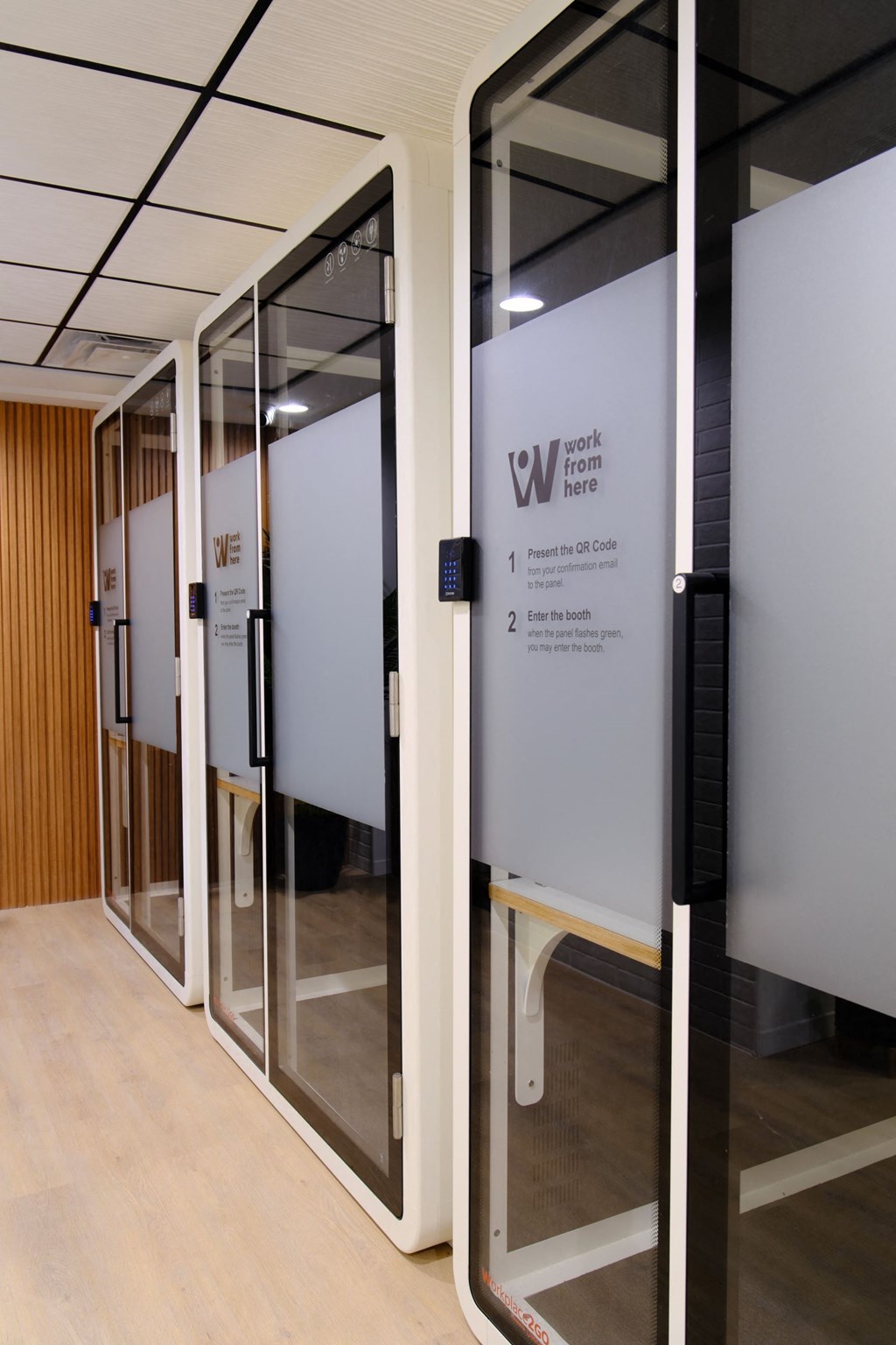 a row of glass doors with a white sign on the side of them