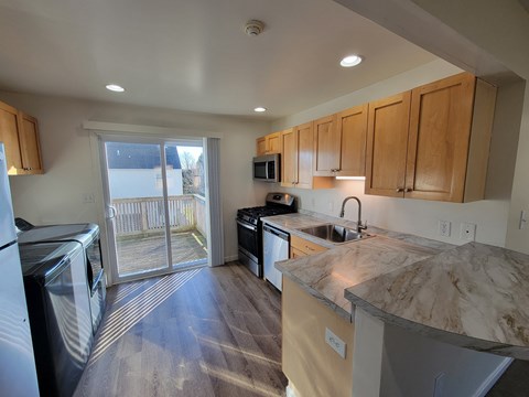 A kitchen with a washer and dryer in it.