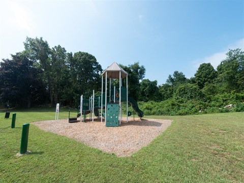 a playground with a swing set in a park