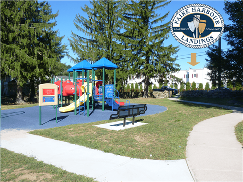a park with a playground and a picnic bench