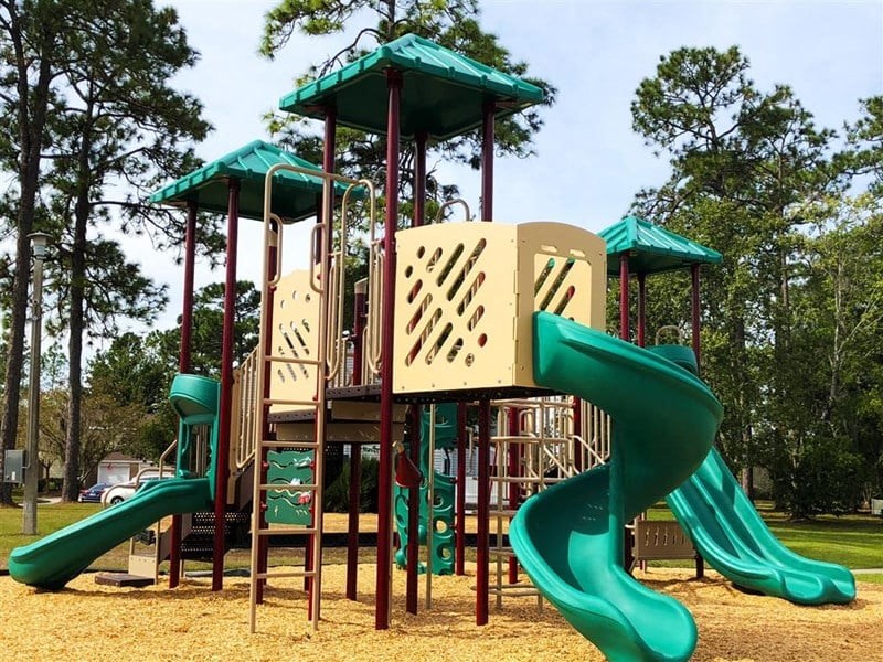 a playground with a swing set and slides