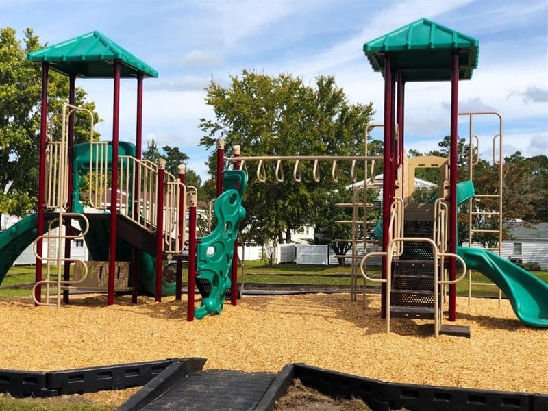 a playground with slides and other toys in a park