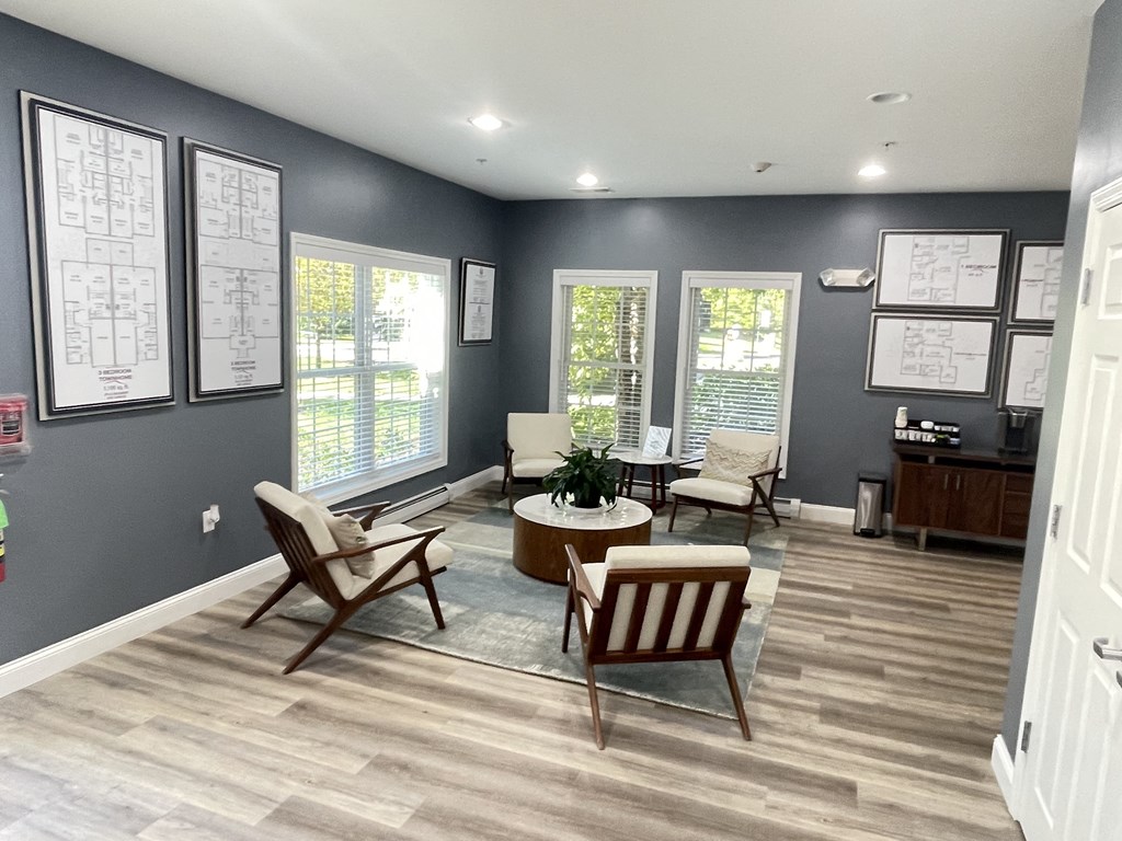 a living room with chairs and a table