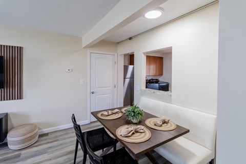 A dining table with plates and a plant on it.