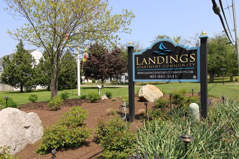 a sign for landsigns amusement park in a park