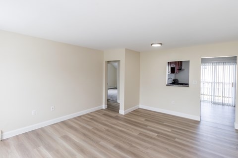 A room with light colored walls and a wooden floor.