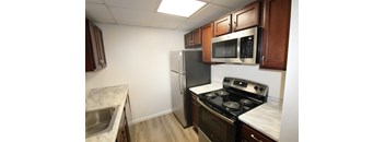 a kitchen with stainless steel appliances and wooden cabinets