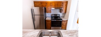 a kitchen with stainless steel appliances and wooden cabinets