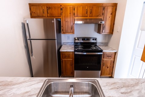 a kitchen with stainless steel appliances and wooden cabinets