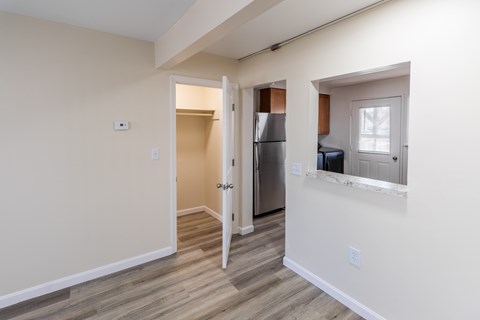 A kitchen area with a refrigerator, sink, and a window.