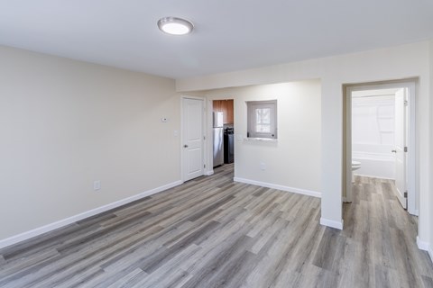 A room with a light grey floor and white walls.
