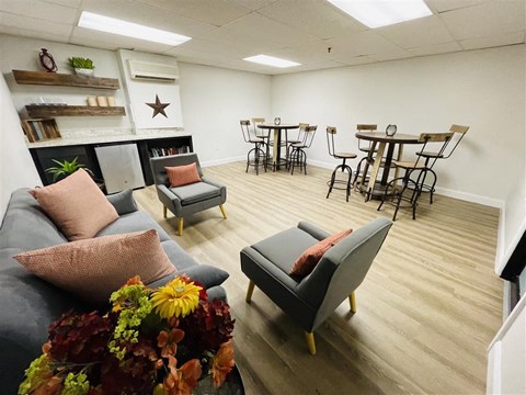 a living room with couches and chairs and a dining room table