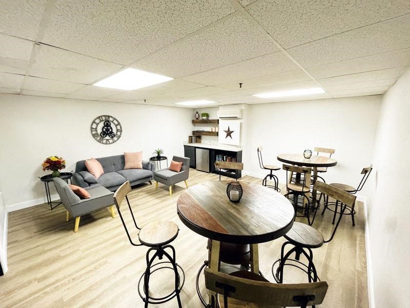 a living room with a table and chairs
