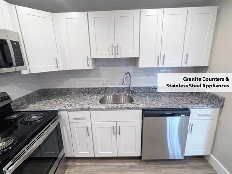 a kitchen with white cabinets and stainless steel appliances