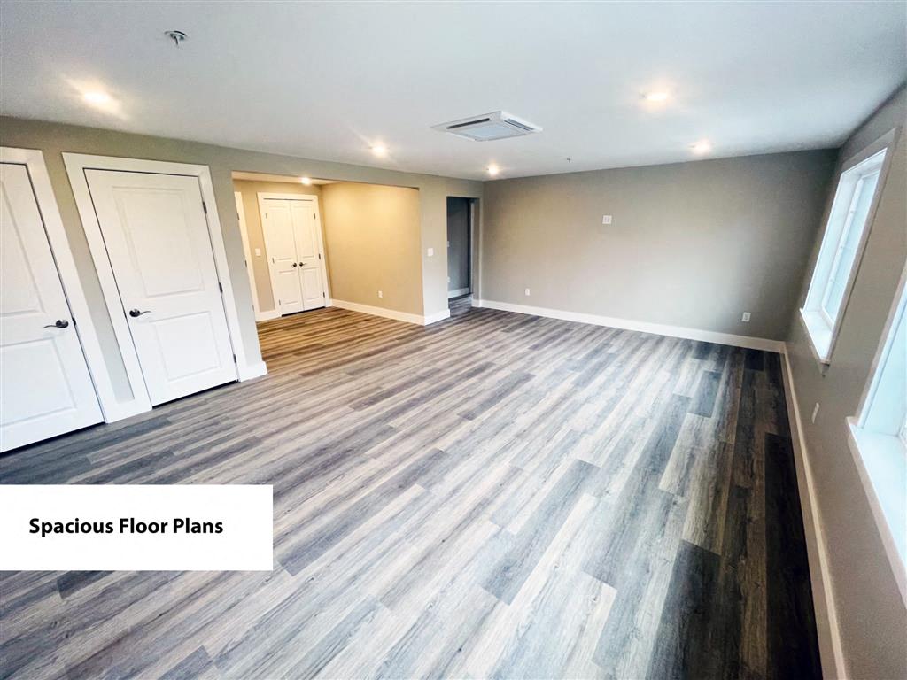 the living room of a new home with wood flooring