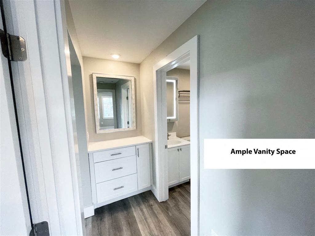 a small bathroom with a vanity and a mirror