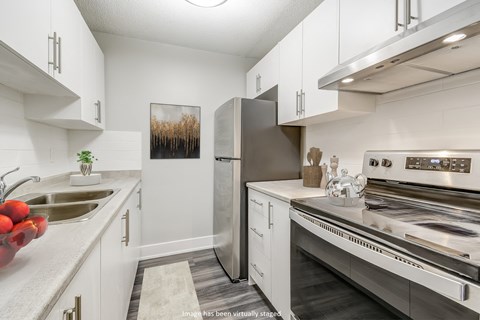 a kitchen with stainless steel appliances and white cabinets