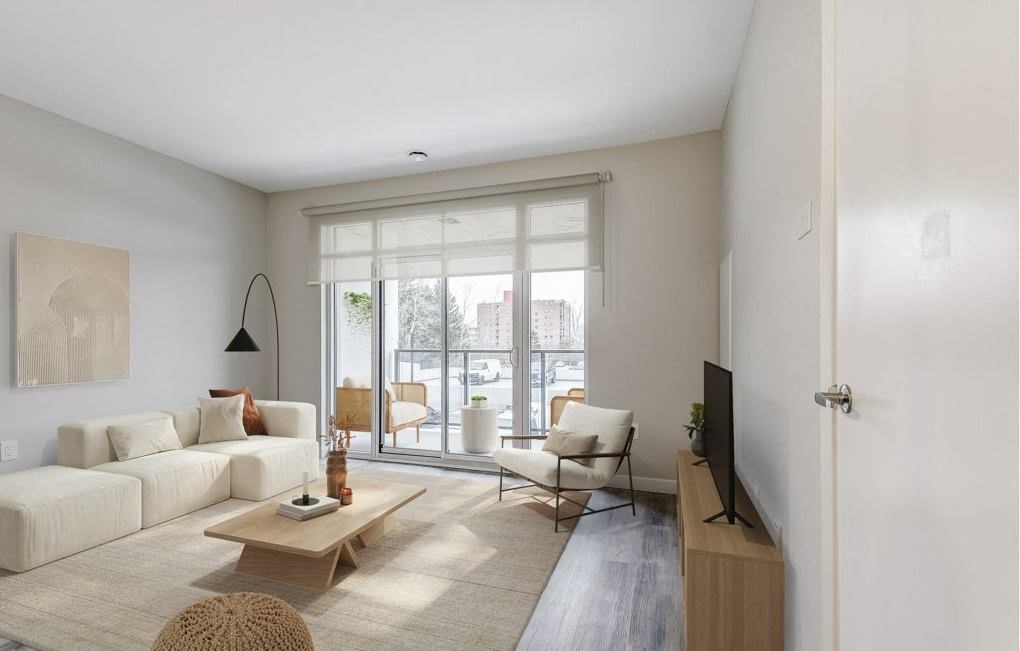 Living room with a white couch and a sliding glass door  at 101 Base Line Road West, London