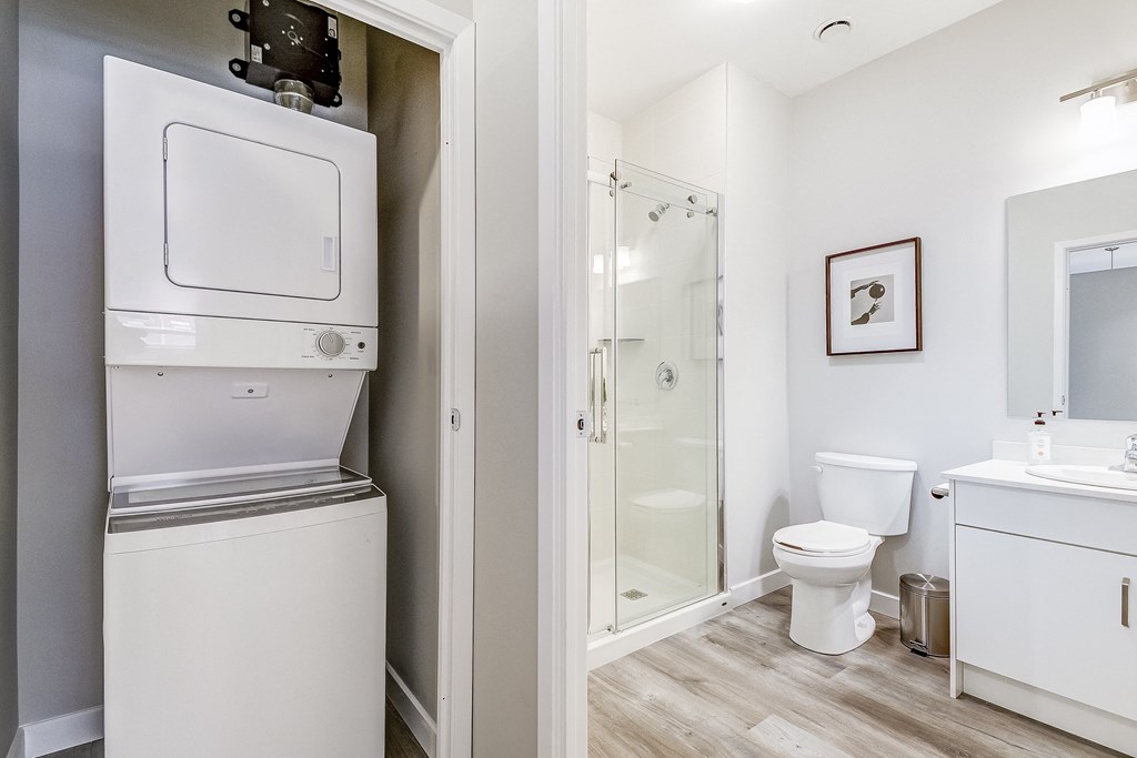 Stacked washer/dryer and bathroom with walk in shower at 101 Base Line Road West, London, Ontario