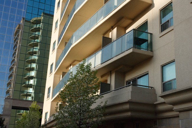 an apartment building with a tree in front of it