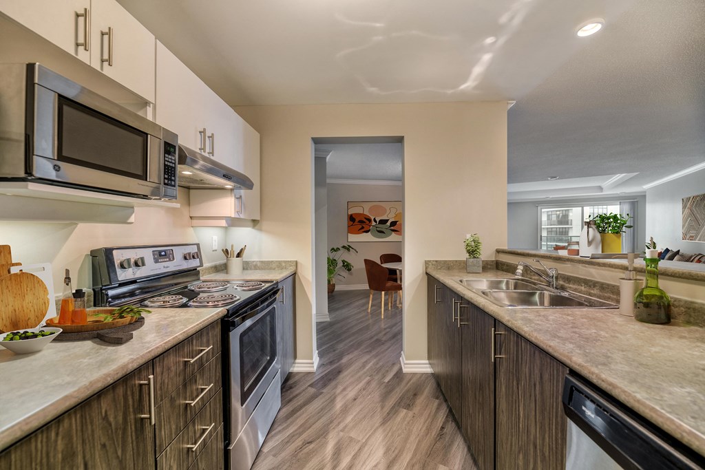 a kitchen with white cabinets and a wooden floor