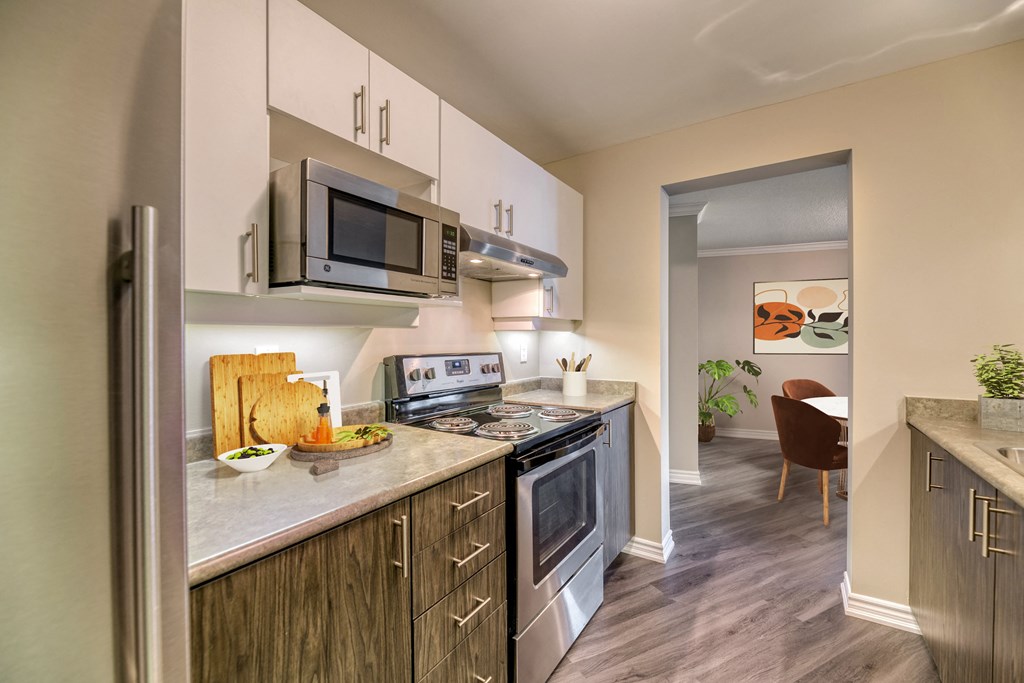 a kitchen with white cabinets and stainless steel appliances