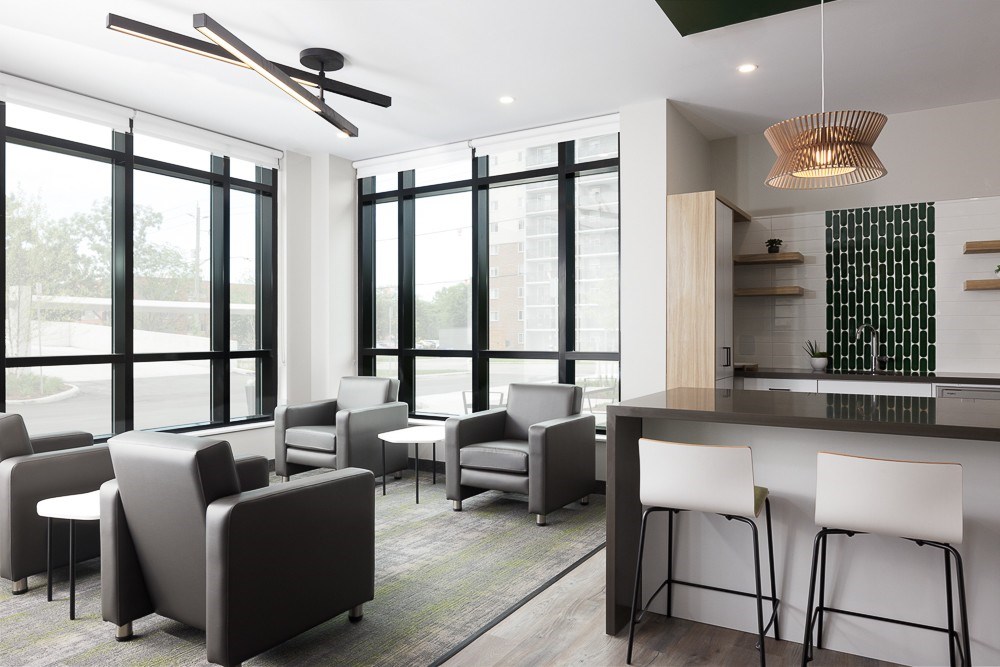 A modern living room with grey and white furniture.