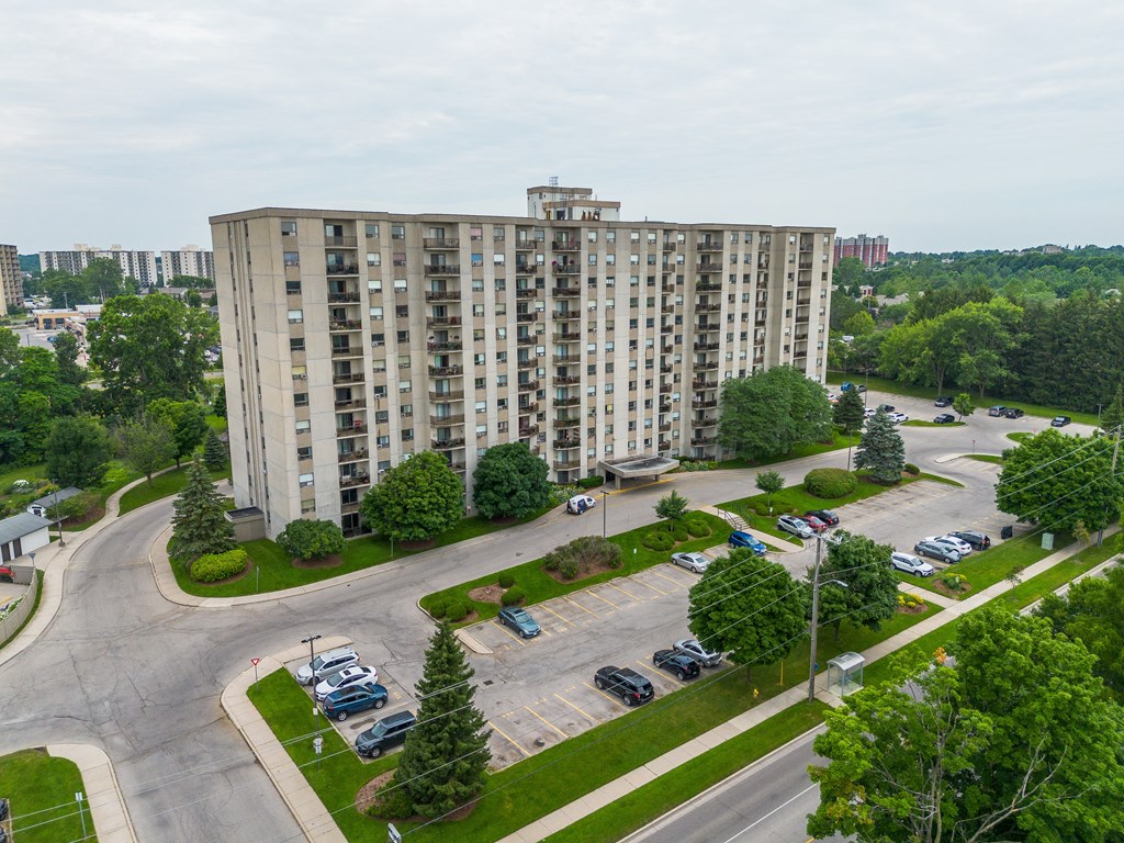 an aerial view of a large apartment building in a parking lot